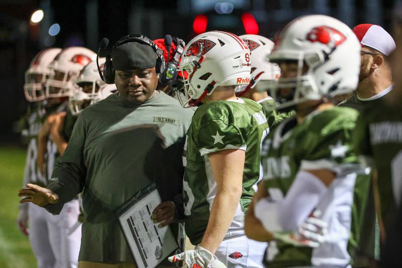 Aiden Ferris of Streator speaks with coach on sideline during game on Friday, October 4, 2024 at Streator high school in Streator.