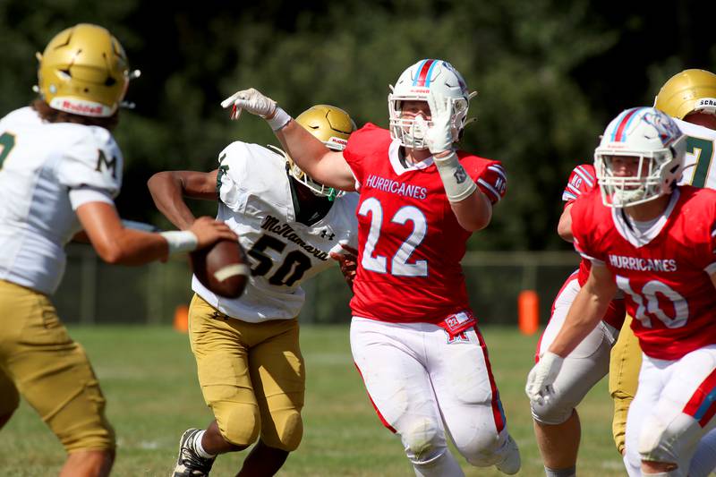 Marian Central’s Andrew Thielsen, center, and and Dan French, right, pressure Bishop McNamara’s quarterback in varsity football action on Saturday, Sept. 14, 2024, at George Harding Field on the campus of Marian Central High School in Woodstock.