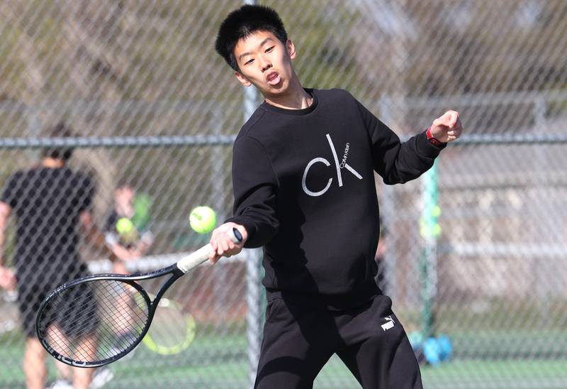 Sycamore number one singles player Steven Chen hits a forehand Wednesday, April 26, 2023, during their match against DeKalb at Sycamore High School.