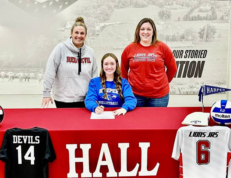 Hall High School senior Taylor Coutts signs to continue her volleyball career at Harper College. She is joined by Hall coach Carolyn Foster (left) and Kim Zimmerman, her 18U Lions Jr. Club coach.