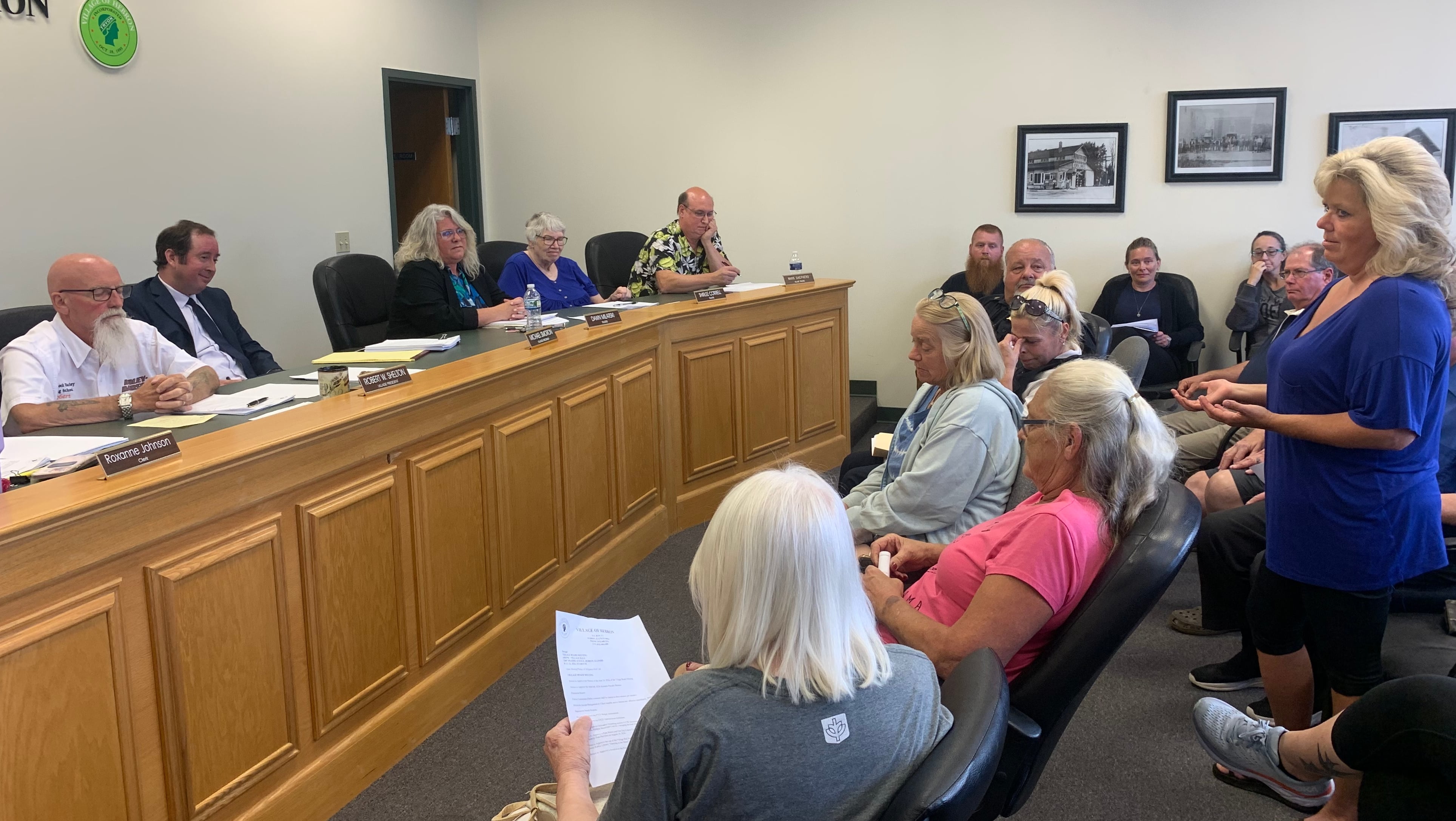 A resident speaks in support of Hebron police Chief Juanita Gumble at a standing-room-only village board meeting on July 22, 2024. Despite residents' pleas, the board voted to dismiss Gumble. Village President Robert Shelton, at far left, said Gumble had tendered her resignation, which she denied.