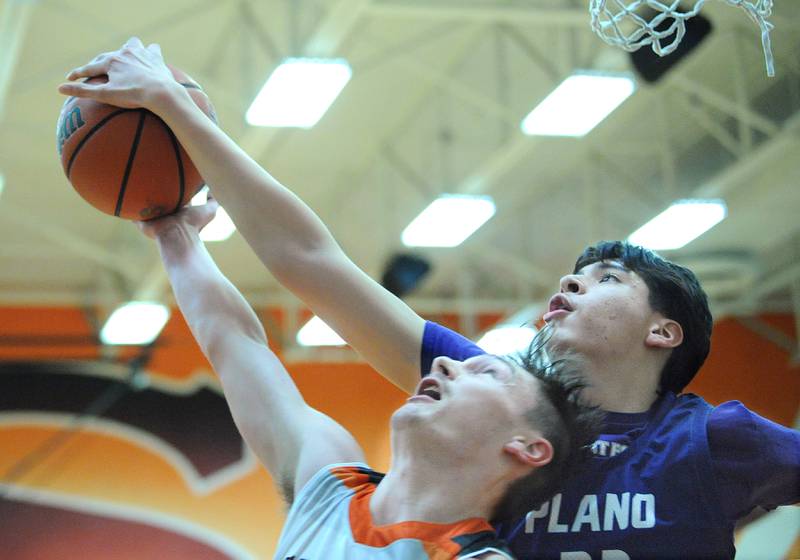 Plano's Isaiah Martinez (right) blocks a shot by Sandwich's Chance Lange during a varsity basketball game at Sandwich High School on Tuesday, Feb. 13, 2024.