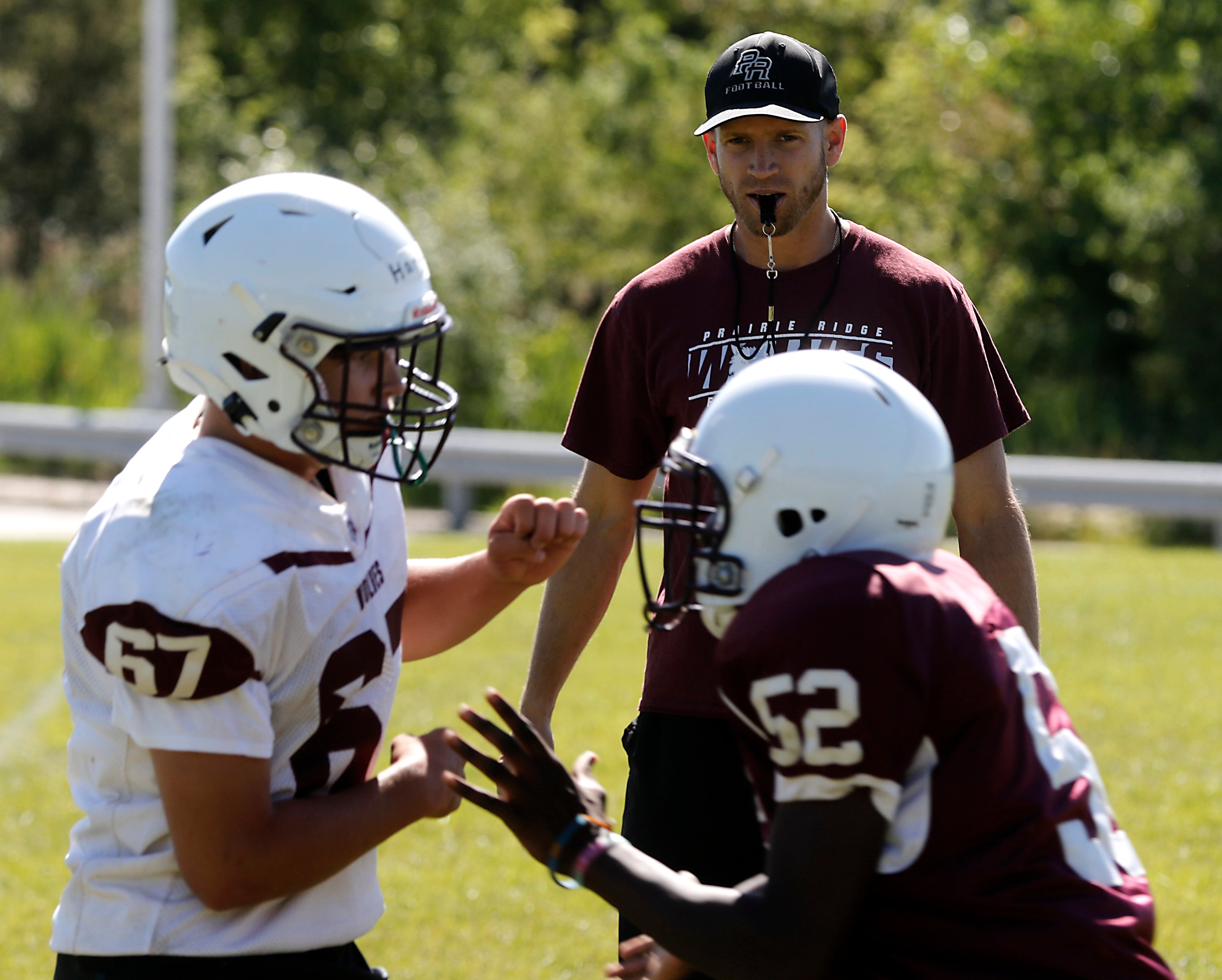 Prairie Ridge Head coach Michael Frericks watches a drill during football practice Monday, July 1, 2024, at Prairie Ridge High School .