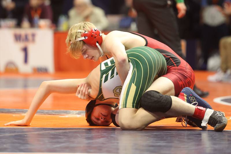 Streator’s Nicolas Pollett works over St. Patrick’s Daniel Goodwin in the 106-pound Class 2A state 5th place match earlier this year in Champaign.