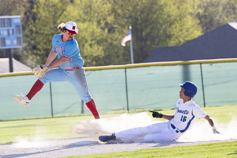 Hall’s Payton Dye comes down with the ball as Newman’s Isaiah Williams slides in safe at second Monday, April 15, 2024 at Newman High School.