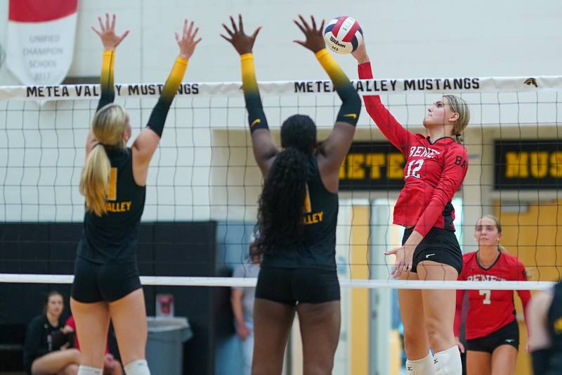 Benet’s Lynney Tarnow (12) plays the ball above the net against Metea Valley's Maddie Hopkins (11) and Addison Torain (6) during a volleyball match at Metea Valley High School in Aurora on Wednesday, Sep 4, 2024.