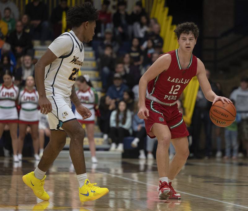 LaSalle-Peru’s Michael Hartman brings the ball up court against Sterling Friday, Feb. 23, 2024 during a class 3A regional final at Sterling High School.