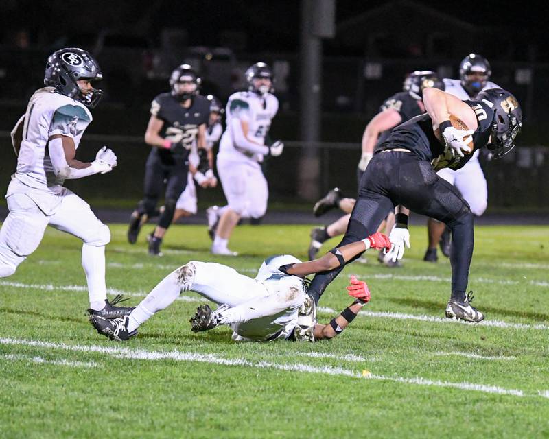 Sycamore Burke Gautcher (10) escapes an Evergreen Park player as he catches an interception during the second quarter held on Friday Oct. 27, 2023, at Sycamore High School.