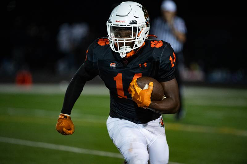 Plainfield Easts Shawn Harris runs the ball during a game against Oswego East on Thursday Sept. 12, 2024 at Plainfield East High School