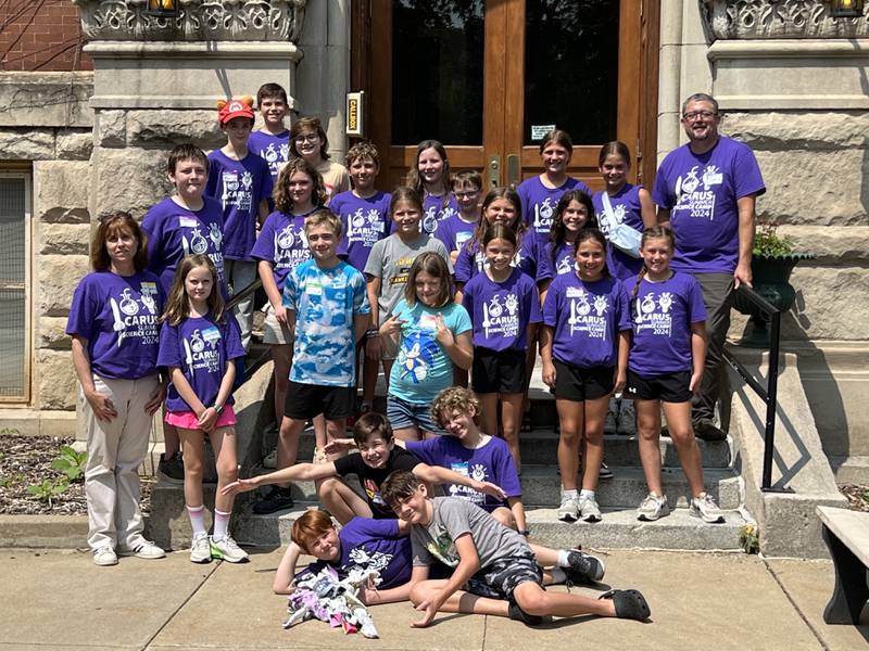 Camp director Dan Fitzpatrick (far right) and Angelique Depenbrock (far left) pose with the 2024 Carus Science Camp participants.