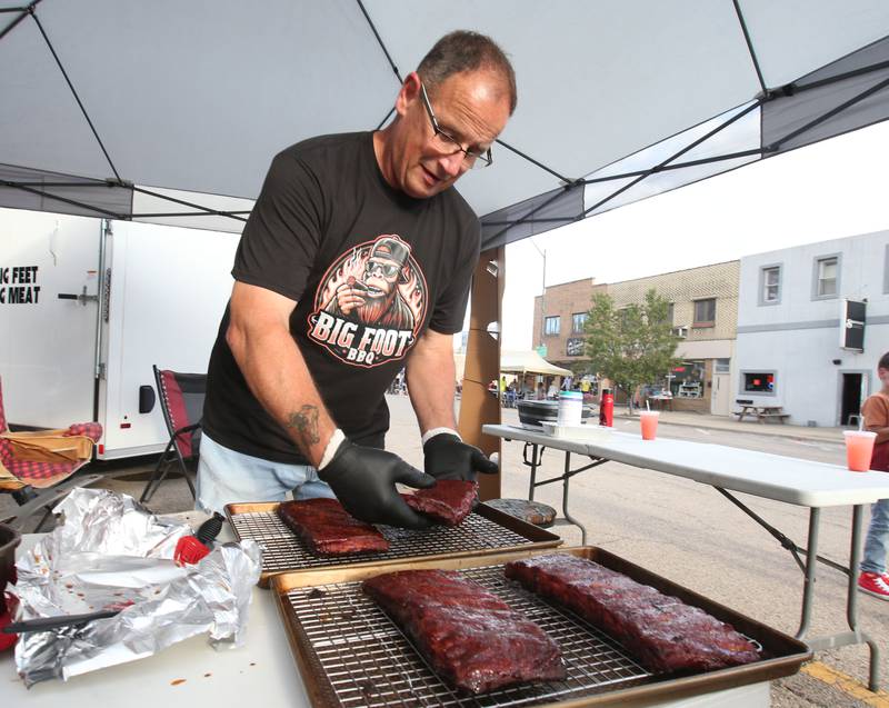 Paul Goluba of Streator handles his racks of ribs hot off of the grill during the BBQ and Blues festival on Friday, Sept. 13, 2024 downtown La Salle.