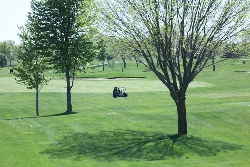 A golf cart moves along the course at the Bolingbrook Golf Club on Tuesday, April 30, 2024.