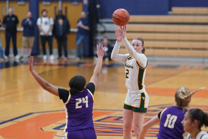 Waubonsie Valley's Hannah Laub (2) shoot a three pointer against Downers Grove North's Kaitlyn Parker (24) during a Oswego semifinal sectional 4A basketball game at Oswego High School on Tuesday, Feb 20, 2024.