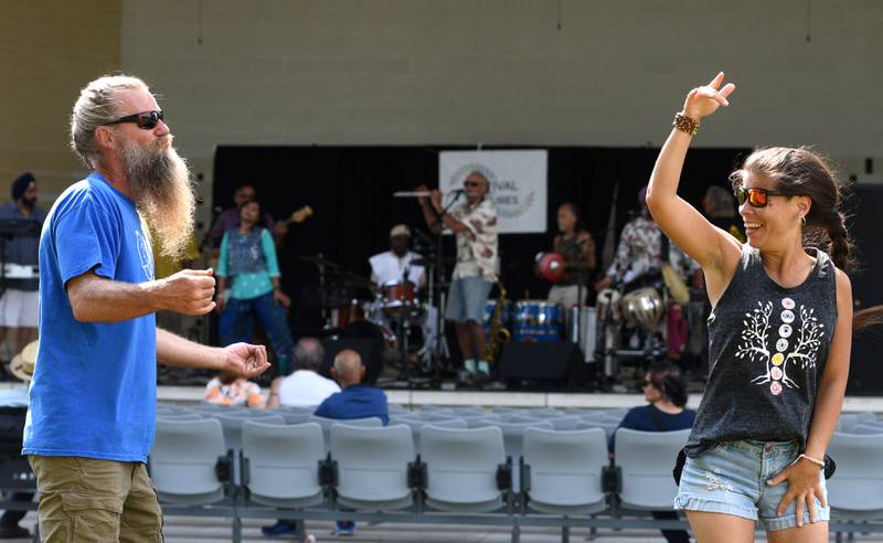 Patrick Bettis and Allison Van der Veen, both of Glen Ellyn, dance to the world music sounds of Funkadesi during Festival of Cultures in at Memorial Park in Wheaton Sunday.