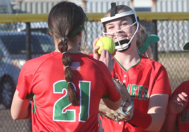 L-P pitcher Taylor Vescogni smiles with teammate Anna Riva  after striking out a Kewanee player on Monday, March 11, 2024 at the L-P Athletic Complex in La Salle.