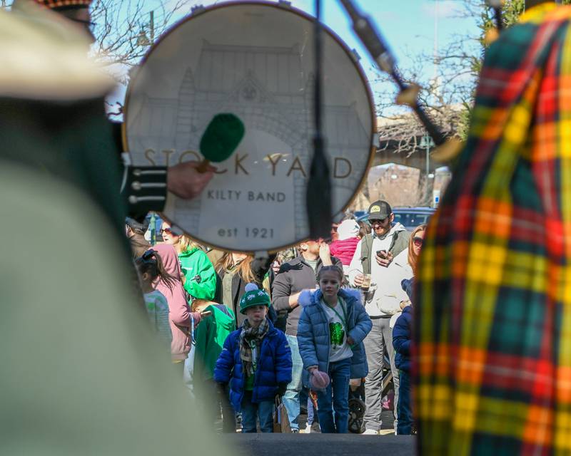 Walker Grogan, 4, and sister Lakelyn Grogan, 6, watch as the Stock Yards bagpipe and drum preform at the Lemont St. Patrick’s festival held Saturday Match, 9, 2023.