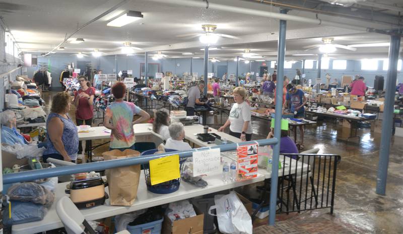 Connie Stauffer, director of the Chana School Museum, coordinates the Chana School's annual rummage sale on Friday. The sale is being held Friday and Saturday in the basement of the Oregon Coliseum on N. Fourth Street and in tents on the building's front lawn. Proceeds from the sale benefit the 1883 historic two-room schoolhouse.