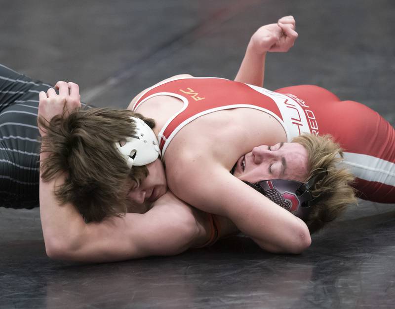 Huntleys' Zack Rogala gets control of Crystal Lake Central's Thomas Hammond during the 138 pound match on Thursday, January 27, 2022 at Huntley High School.