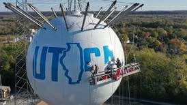 Photos: Crews paint the Utica water tower