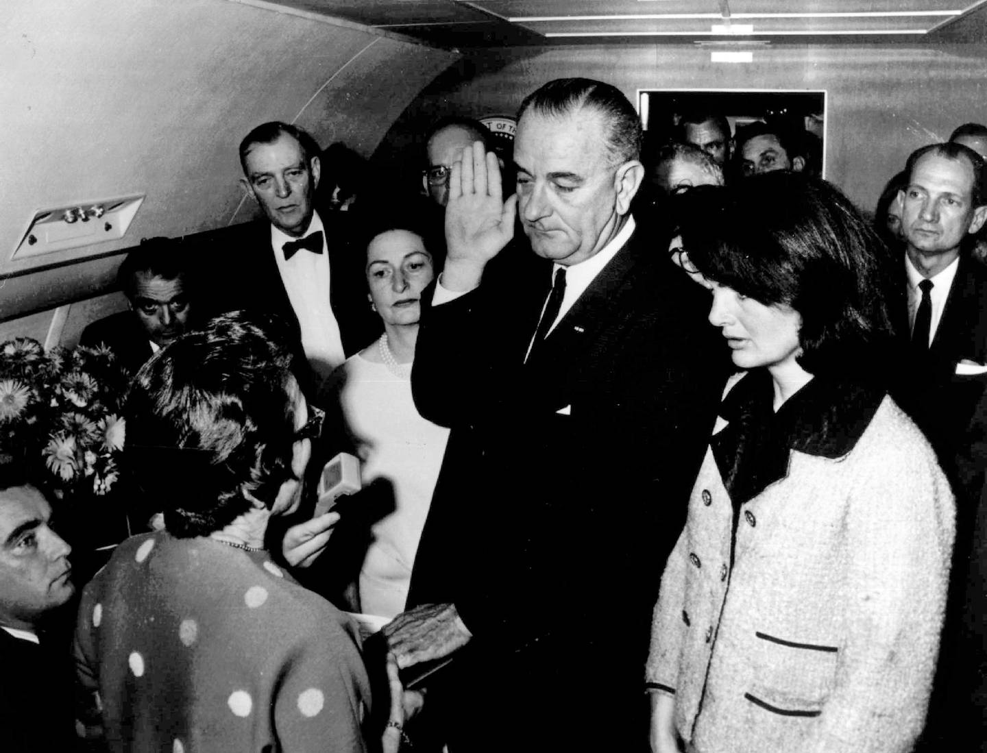 In this Nov. 22, 1963, file photo, Lyndon B. Johnson is sworn in as President of the United States of America in the cabin of the presidential plane as Mrs. Jacqueline Kennedy stands at his side in Dallas, Texas. Judge Sarah T. Hughes, a Kennedy appointee to the Federal court (left) administers the oath.