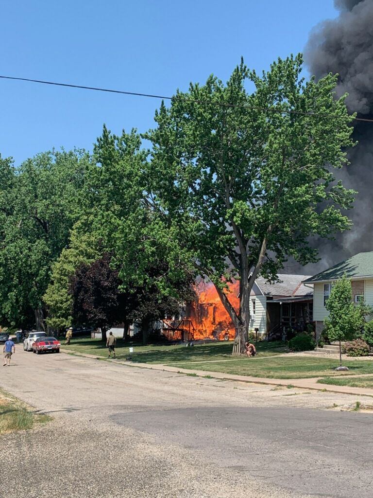 Homes on the 100 block of East Caroline Street are engulfed in flames Saturday, June 10, 2023.