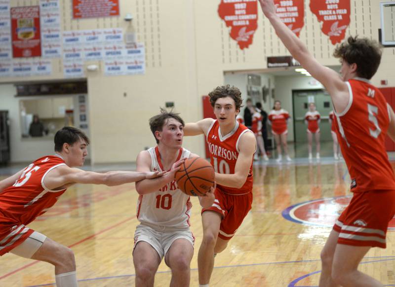 Oregon's Keaton Salsbury (center) drives into the lane as Morrison's. Asher Ernst (15), Colton Bielema (10) and Chase Newman (5) react during 2A regional action on Monday, Feb. 19, 2024 at the Blackhawk Center in Oregon. The Mustangs downed the Hawks 59-52 to advance to the Prophetstown Regional on Wednesday, Feb. 21.