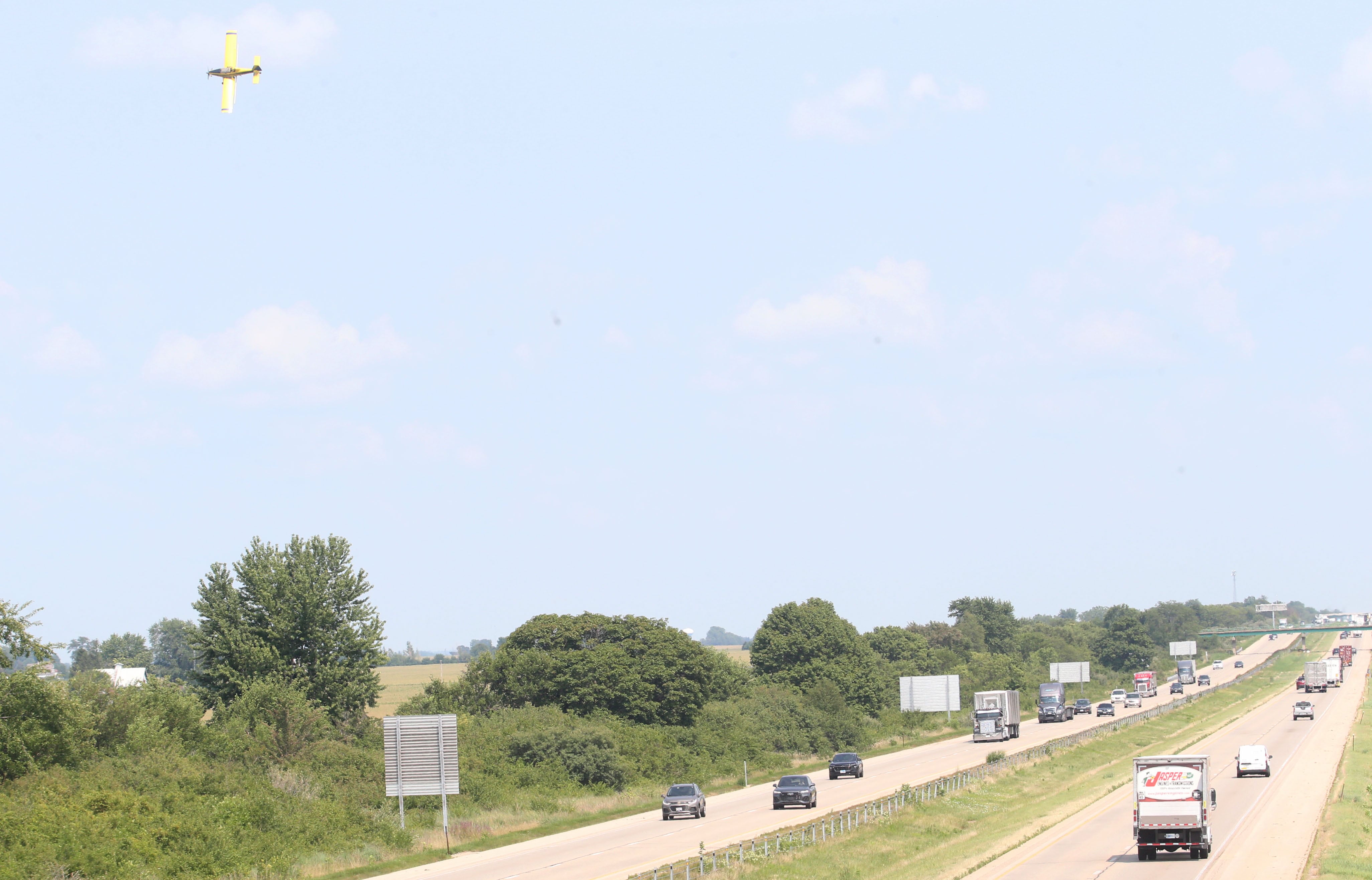 A crop duster airplane sprays a field near the intersection of East 9th Road and Interstate 80 on Monday, July 22, 2024 near Utica.