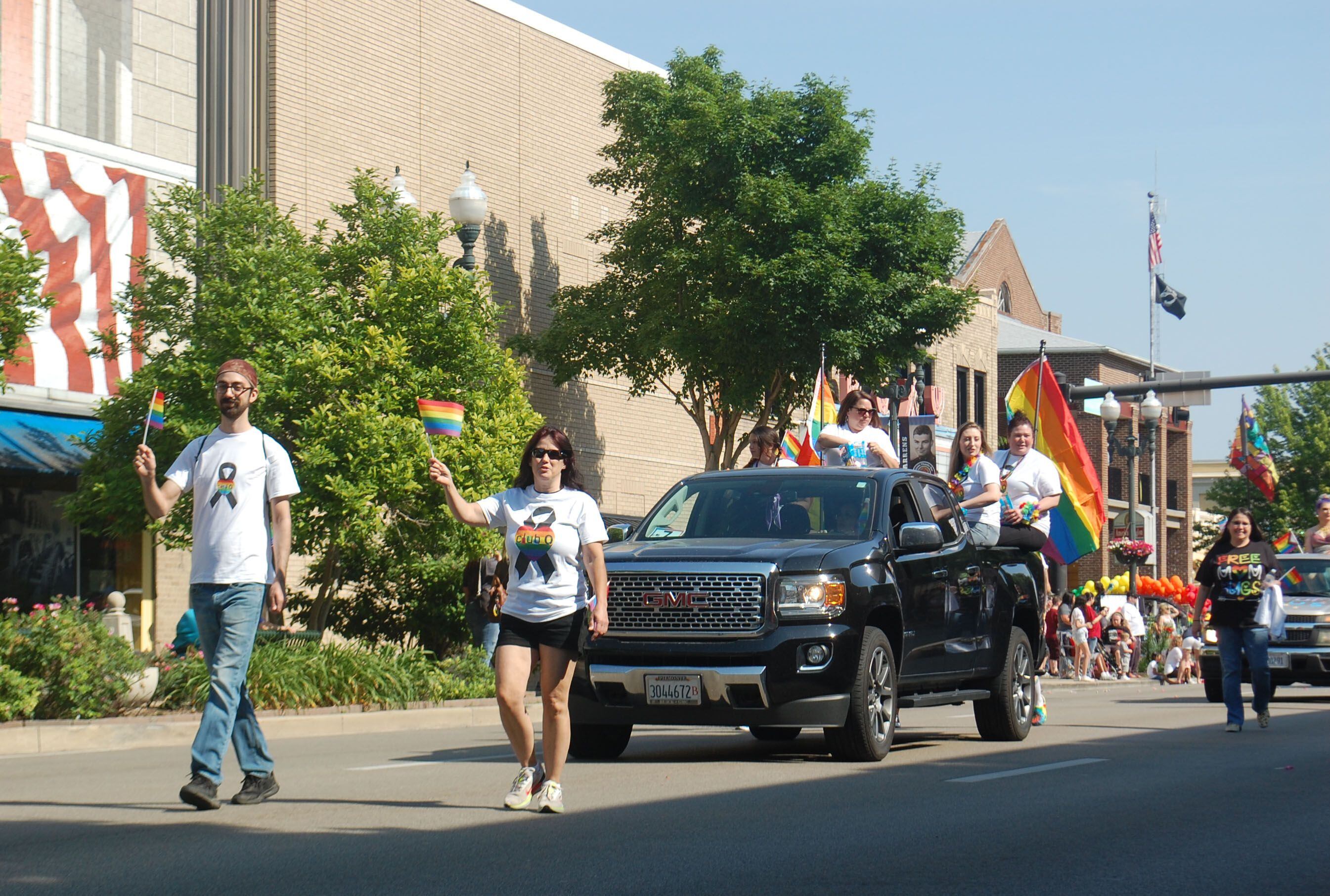 Parade participants proudly display their rainbow flags as they march down La Salle Street in downtown Ottawa on Saturday, June 10, 2023.