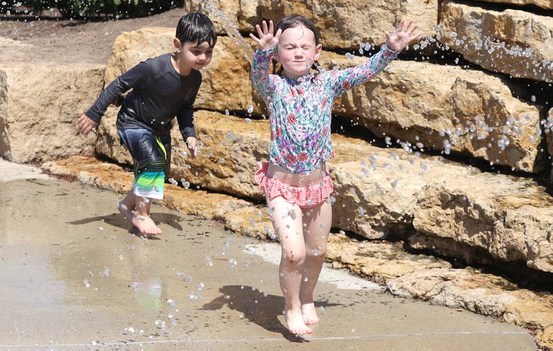 Scarlett Thunder, (right) 4, and her friend Veeshan Mustafa, 4, both from Sycamore, cool off Tuesday, June 14, 2022, at the Sycamore Park District’s Splash Fountain. Temperatures reached nearly 100 degrees Tuesday and highs are expected to remain in the 90's through Thursday.