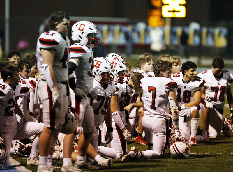 Benet watches as their teammate Sean McKeague (13) is tended to by medical staff during the varsity football game between Benet and Nazareth academies on Friday, Oct. 18, 2024 in La Grange Park.