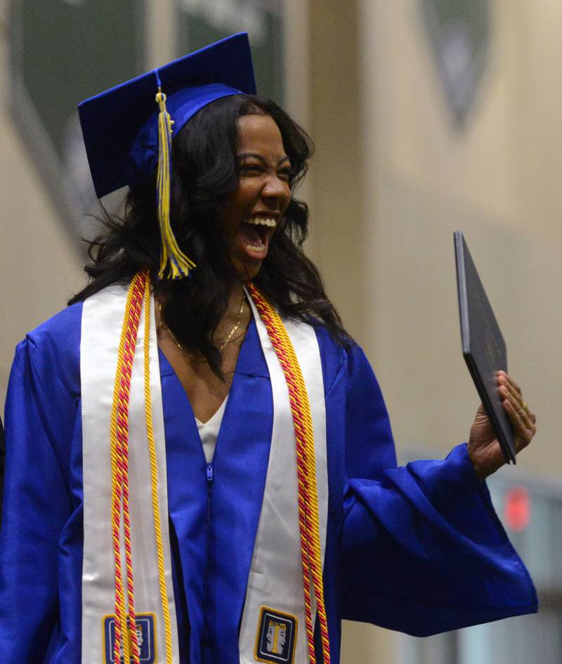 Joe Lewnard/jlewnard@dailyherald.com
Zoe Elese Shores-Navata holds up her diploma in celebration during the Wheaton North High School graduation, held at the College of DuPage in Glen Ellyn Saturday.