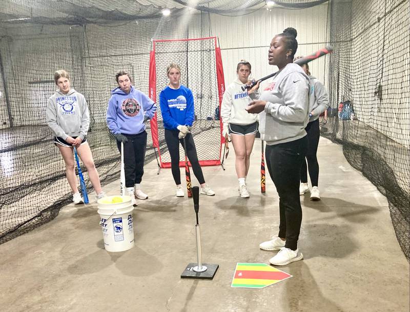 First-year Princeton softball coach Jhavon Hayes works on hitting instruction with her team during Wednesday's practice at their hitting facility outside of Malden. She was a four-year standout at Illinois State.