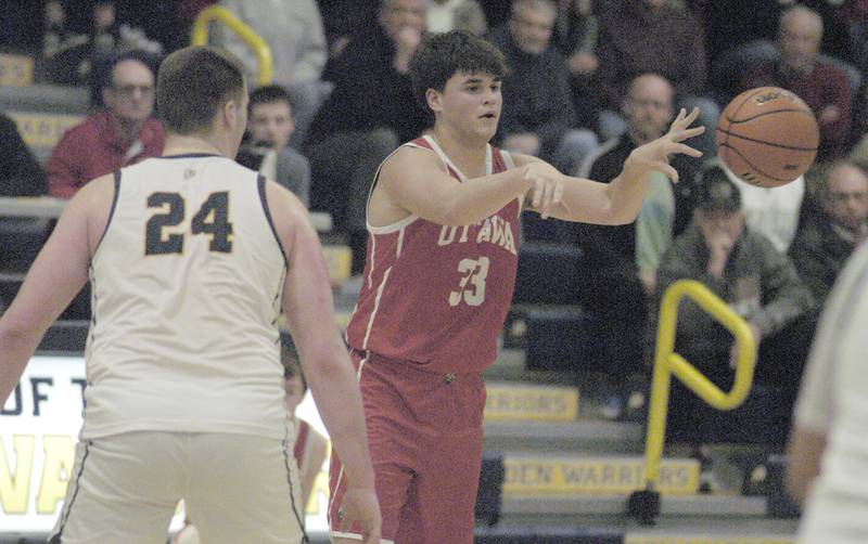 Ottawa's Cooper Knoll dishes the ball off  during Sterling’s 3A Regional semifinal game Wednesday, Feb. 21, 2024, at Sterling High School.