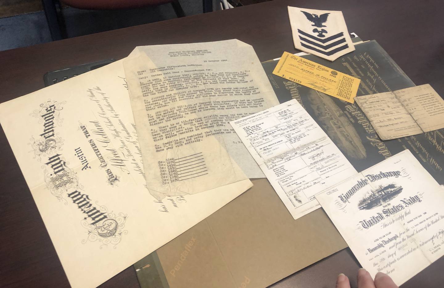 Stacy Heiliger, the new Harvard Parks and Recreation superintendent, is looking for Alfred Collard's family to return his U.S. Navy documents to them, found in a filing cabinet she bought online.