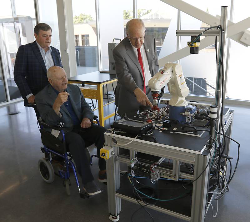 Vince Foglia (center) and his son, Vinnie, (left) and U.S. Rep. Bill Foster, (right) who now represents much of McHenry County, look at a robotic arm as they tour the Foglia Center for Advanced Technology and Innovation on Tuesday, Sept. 3, 2024, at McHenry County College.