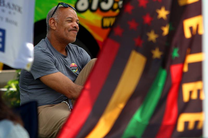 Terry Harris of Crystal Lake listens to live music from Kenny Davis & Band during McHenry County’s 2nd Annual Juneteenth Festival at the Woodstock Square Saturday.