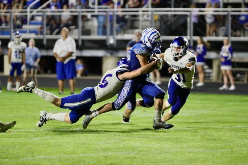 Princeton's Ace Christiansen tries to shake off Neman's Daniel Kelly and Cody McBride (31) and teammate Friday night at Bryant Field. The Tigers won 28-14.