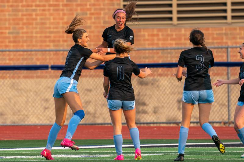 St. Charles North's Bella Najera (center) celebrates after scoring a goal against Wheaton Warenville South during the Class 3A girls soccer regional final at St. Charles North High School on Friday, May 19, 2023.