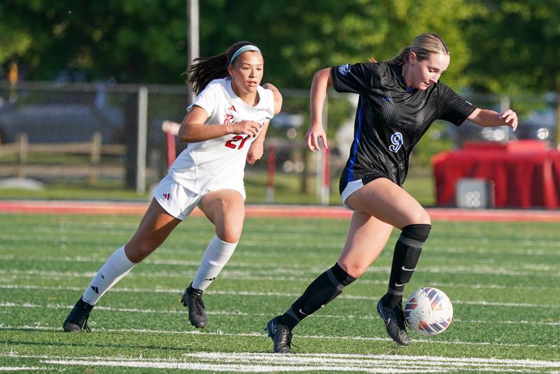 St. Charles North's Addyson Priess (9) plays the ball against Batavia’s Addison Lowe (21) during a Class 3A Batavia Regional final soccer match at Batavia High School in Batavia on Friday, May 17, 2024.