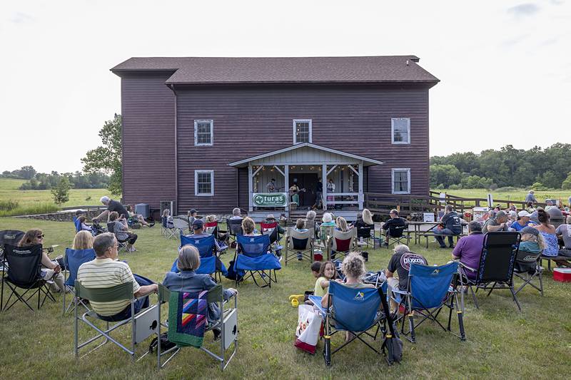 A crowd gathers on the lawn of the grist mill at Franklin Creek State Park Saturday, June 22, 2024 for a summer solstice celebration and fundraiser for the park.