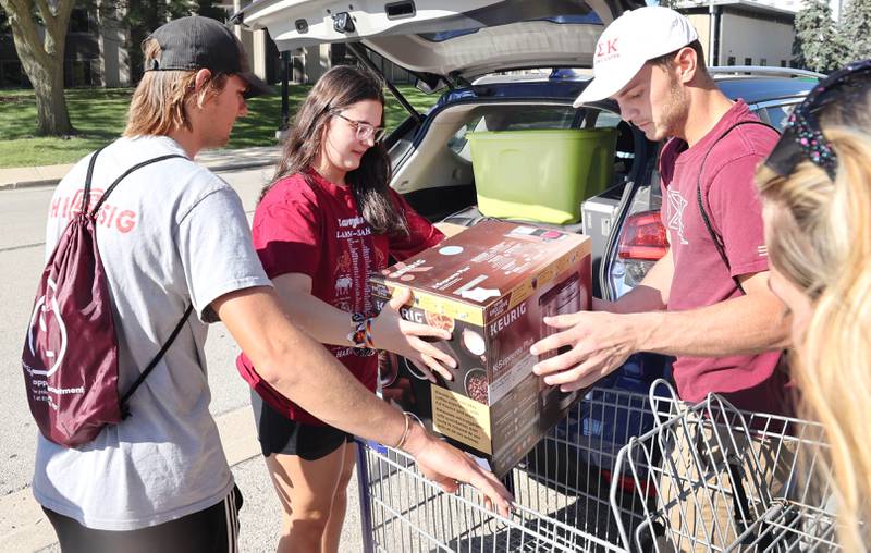 Northern Illinois University sophomore Gabby Gozdecki, (middle) from Palatine, gets some help from volunteers from the Phi Sigma Kappa fraternity unloading her van Thursday, Aug. 18, 2022, as she moves into New Residence Hall at NIU. Thursday was one of four move-in days for students attending the upcoming school year.