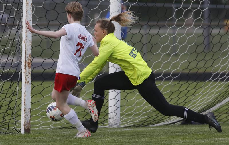 Marian Central'a Natalee Henkel kicks the ball past Johnsburg's Sophie Person to score a goal during the IHSA Class 1A Marengo Regional championship soccer match on Tuesday, May 14, 2024, at Marengo High School.
