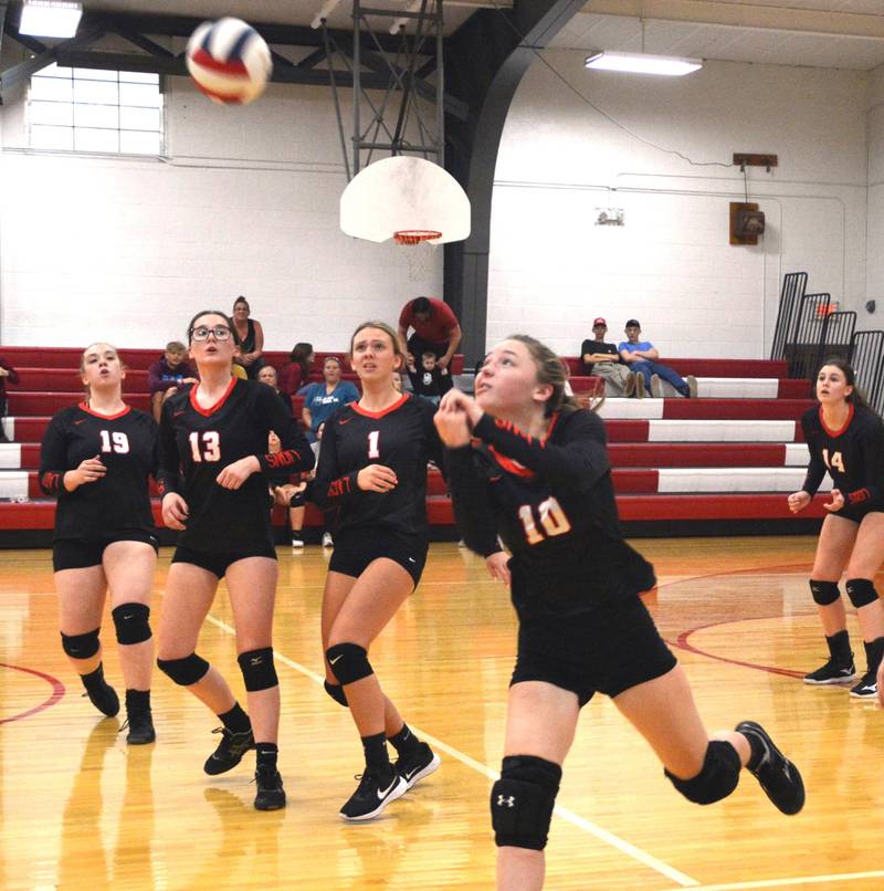 Olivia Sadnick makes a play for LaMoille Thursday night against Leland watched by teammates 19 Nataliegh Wamhoff  (19) Chloe Williams (13), Grace Kelly (1) and Claire Lovgren (14).  Leland won in two sets.