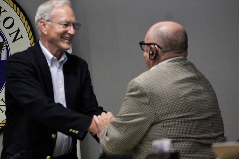 Dixon Mayor Glen Hughes accepts a handshake from Council Member Dennis Considine after being sworn in on Monday, May 1, 2023. Hughes won election over Considine during the April 4 consolidated election.