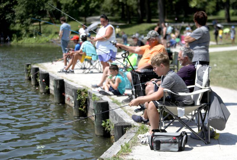 Caleb Vaughan, 11, of Villa Park fishes at Herrick Lake Forest Preserve during the DuPage Forest Preserve Police Cops and Bobbers event in Wheaton on Wednesday, June 19, 2024.