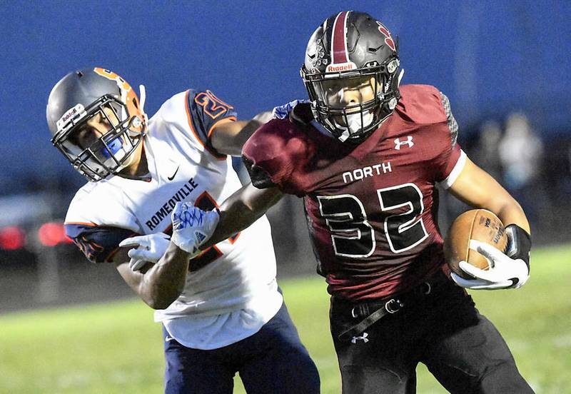 Plainfield North's Tyler Hoosman breaks away from Romeoville's Jorge Ocampo on Friday, Sept. 9, at Plainfield North High School. North defeated Romeoville, 62-6.