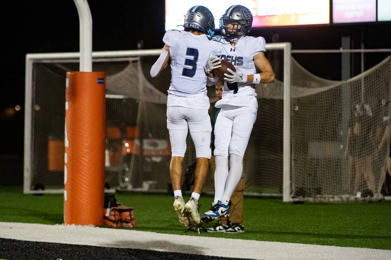 Oswego East's Jeremiah Jenkins andAjontae Greer celebrate Greer's touchdown during a game against Plainfied East on Thursday Sept. 12, 2024 at Plainfield East High School