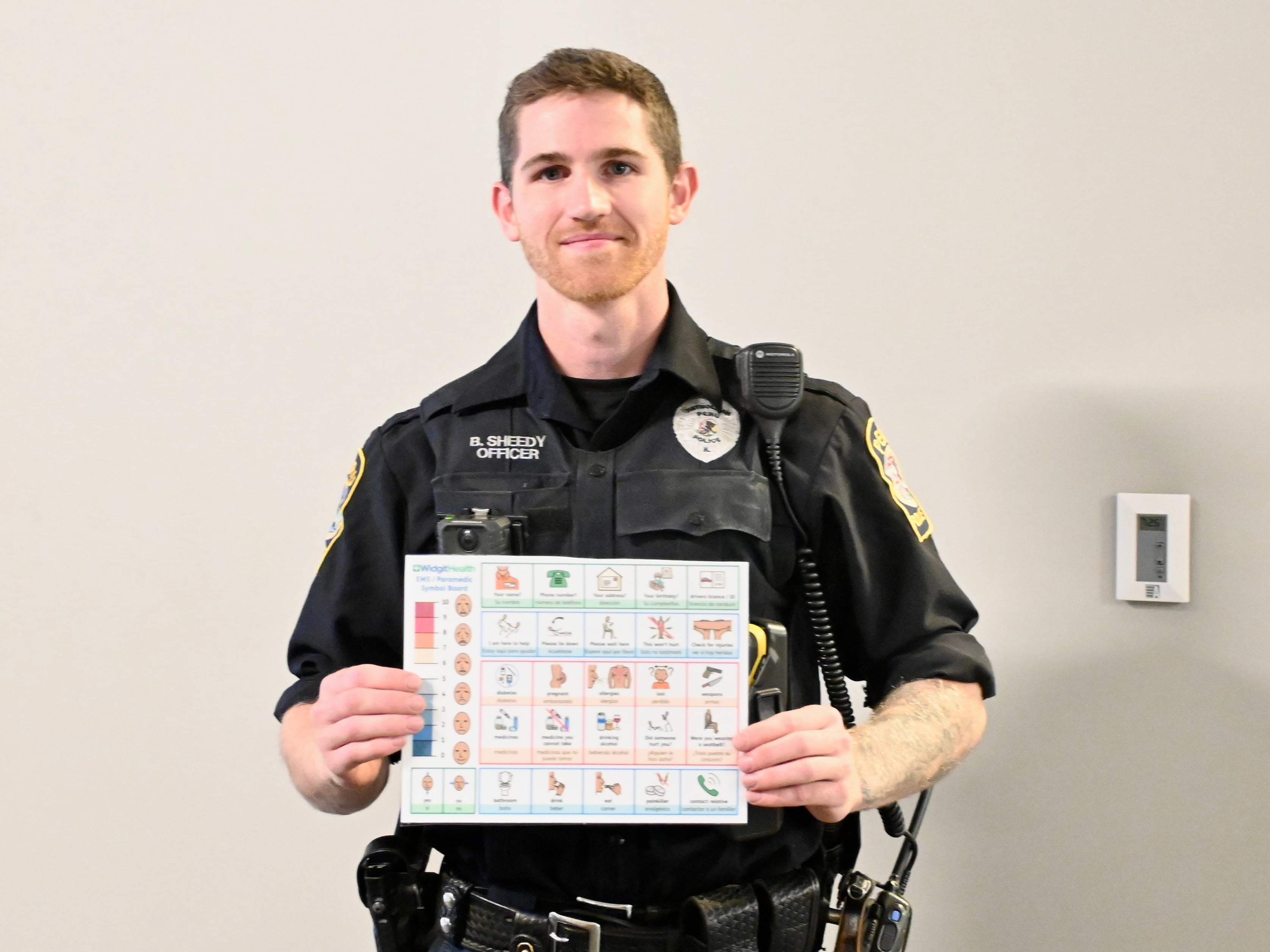 Peru Patrol Officer Brendan Sheedy with a picture communication tool.