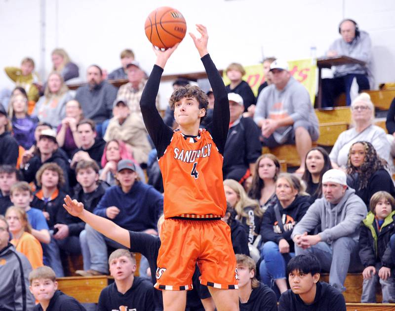 All eyes are on Sandwich's Drew Sullivan as he shoots and makes a three-point basket during a varsity basketball game at Plano High School on Tuesday, Dec. 5, 2023.