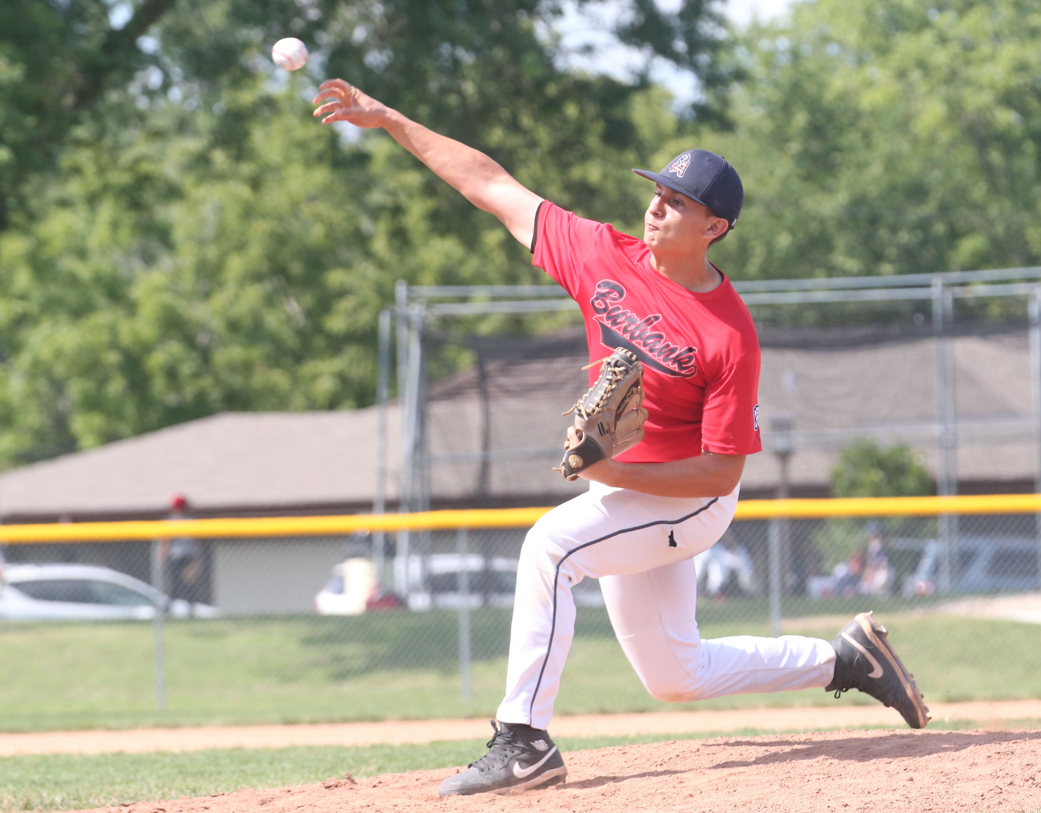 Burbank pitcher Juan Avila lets go of a pitch to Michigan  during the Central Regional  Baseball Tournament championship on Thursday, July 18, 2024 at J.A. Happ Field in Washington Park in Peru.